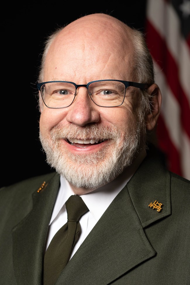 a man wearing a park ranger uniform