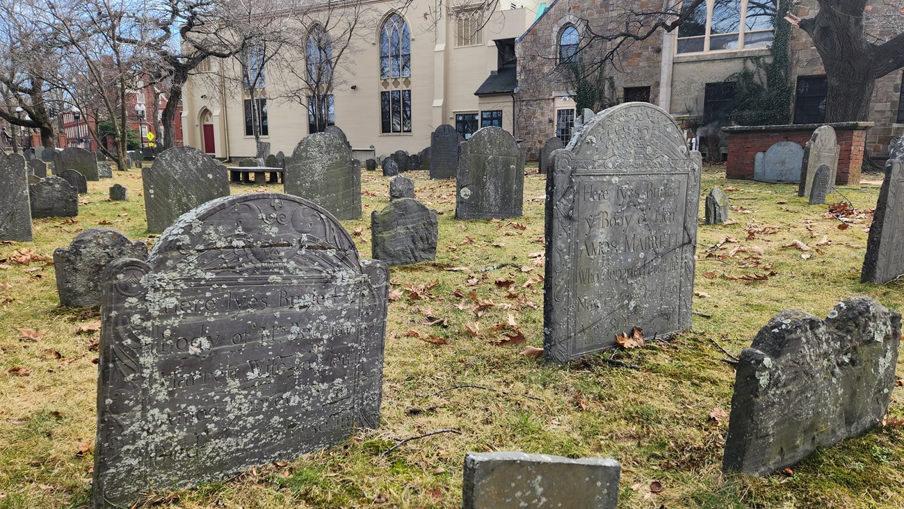 Amos and Bethia Marrett Two stone headstones in a burying ground with partially legible inscriptions for Amos Marrett and Bethia Marrett