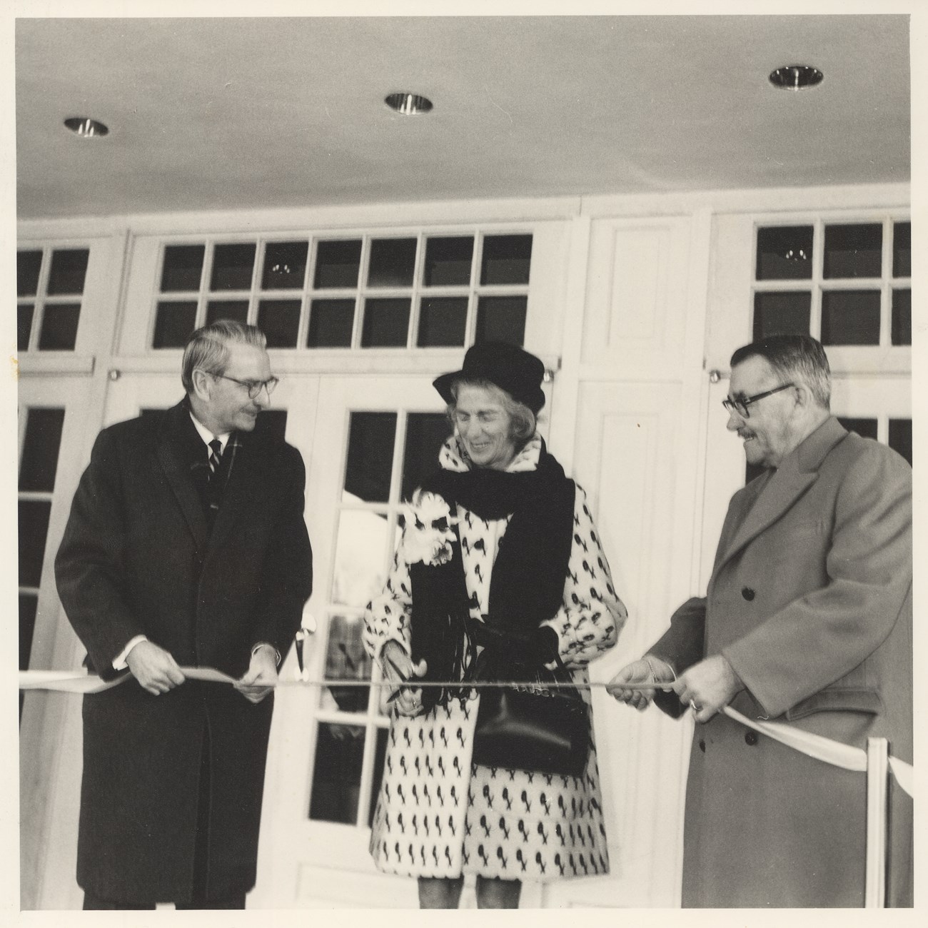 Laurance and Mary Rockefeller with Governor Dean Daviss cutting a ribbon in front of woodstock inn