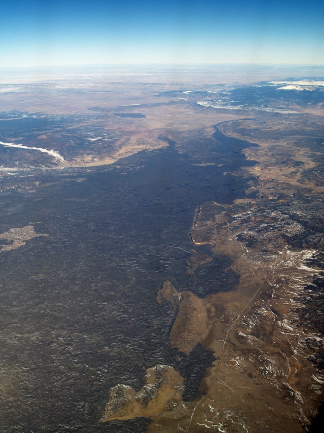 aerial photo of a lava flow covering a large area of land