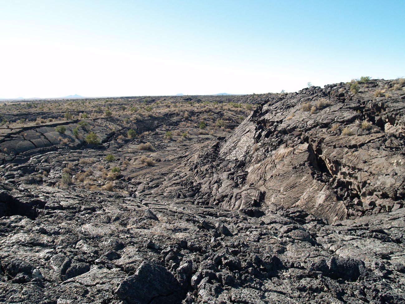 photo of barren rocky land surface with slight depression
