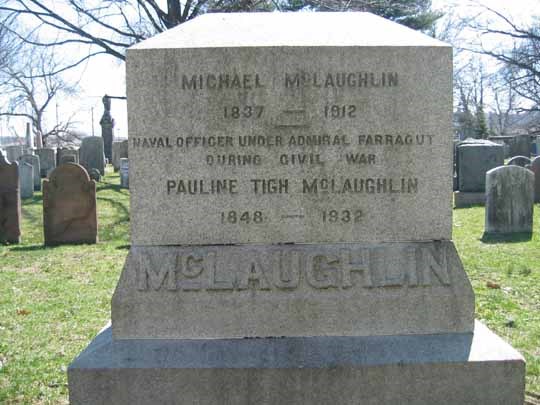 McLaughlinCW Light grey gravestone, with inscription, in a cemetery, surrounded by other gravestones