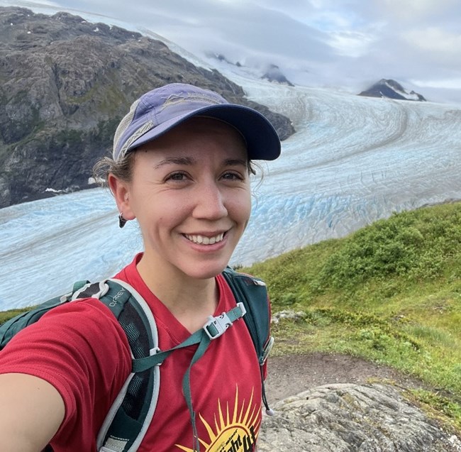 Woman taking selfie in front of rocky landscape
