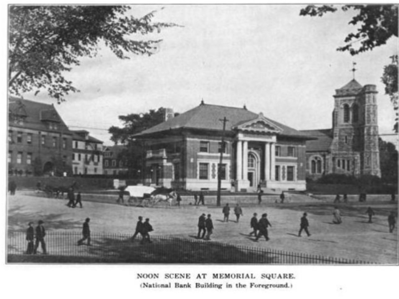 Buildings with church in background and square with kids playing in it