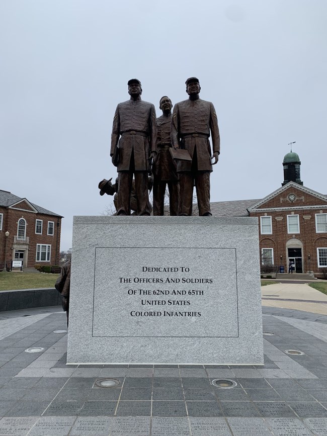 Statue of Civil War soldiers with text that reads, "Dedicated to the Officers and Soldiers of the 62nd and 65th United States Colored Infantries."