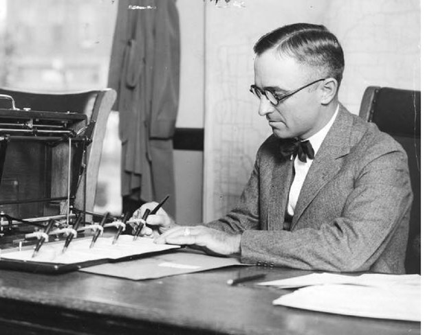 County Judge Harry S Truman using unique check signing machine