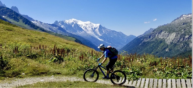 Mike Archer mountain biking A person riding a bike on a mountain trail.