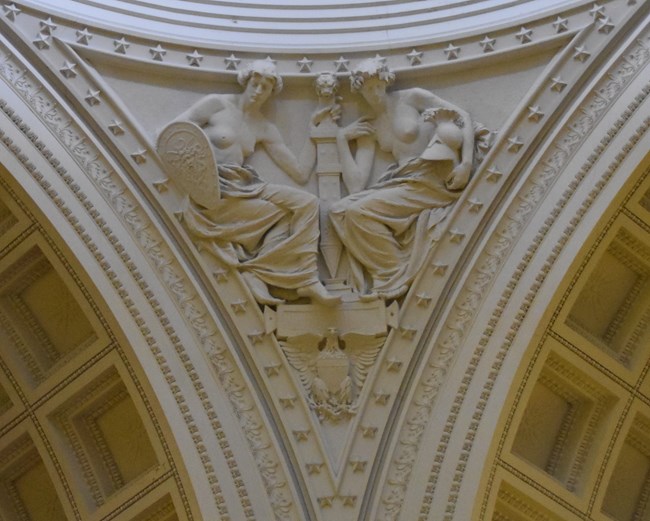 White granite pendentive architecture of two allegorical women