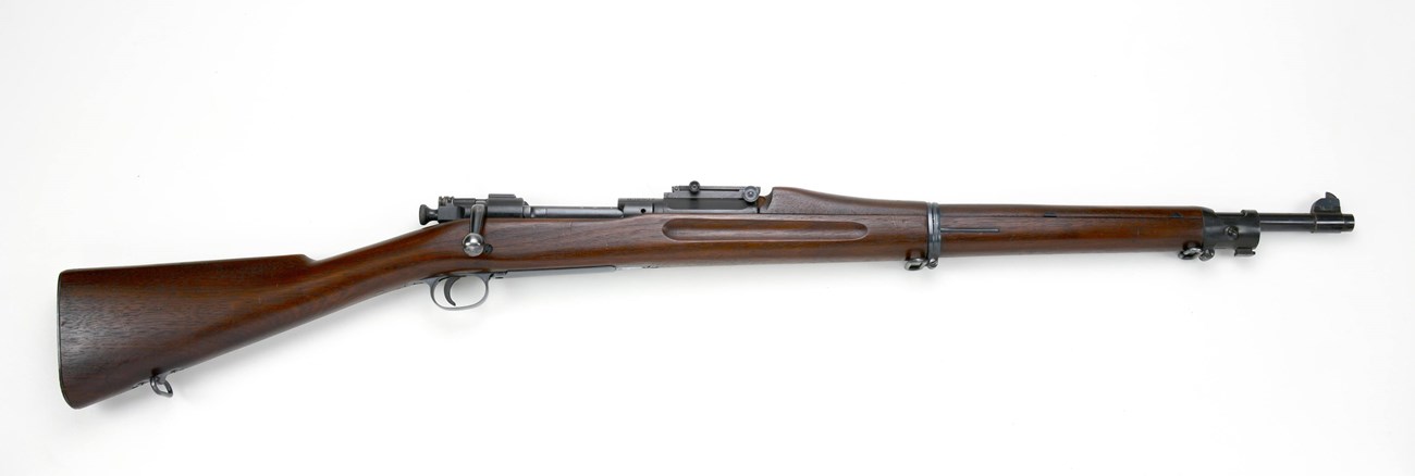 Photograph of a brown rifle.