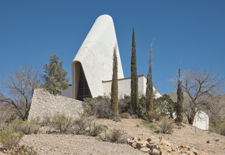 Temple Mount Sinai Synagogue A modernist church with a unique curved roof with angular walls in a desert landscape.