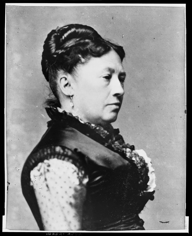 Black and white portrait of Julia from chest up in side profile facing right