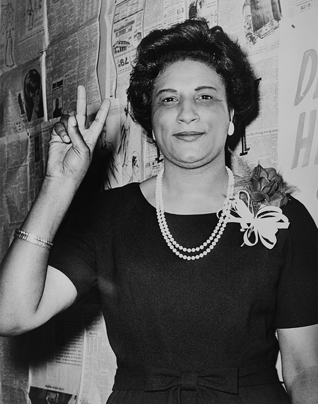 Image of Constance Baker Motley making a peace sign two days after her election as the first African American woman to serve in the New York State Senate.
