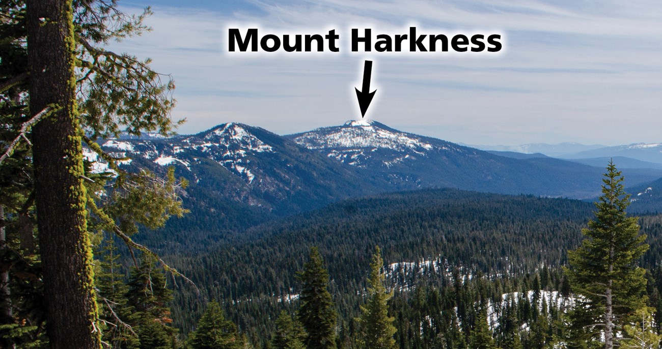 photo of a distant volcanic peak labeled Mount Harkness