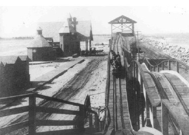 the track of a wooden roller coaster seen from inside a car