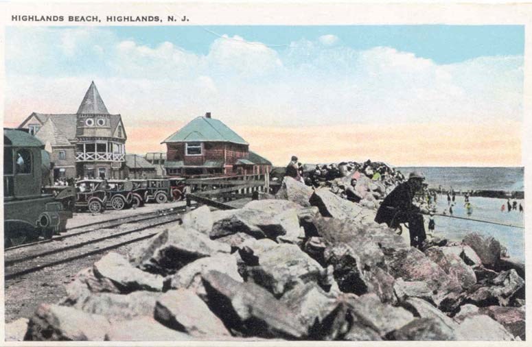 train tracks running alongside boulders