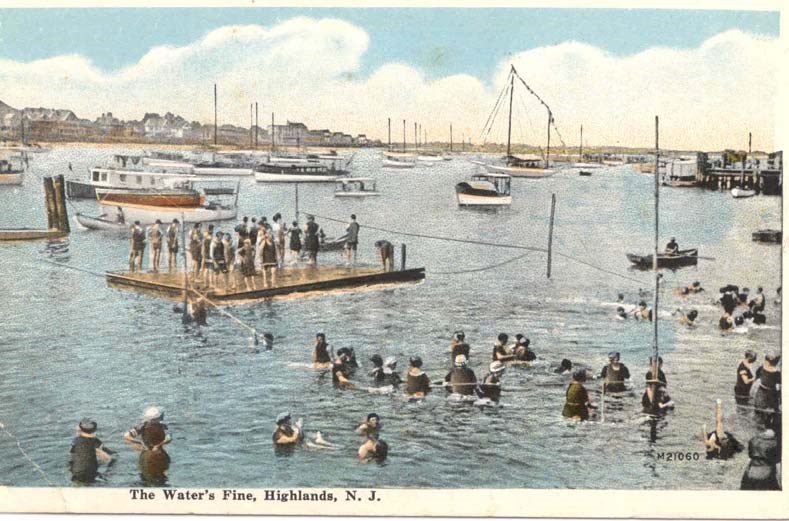 visitors stand on a swim platform surrounded by boats