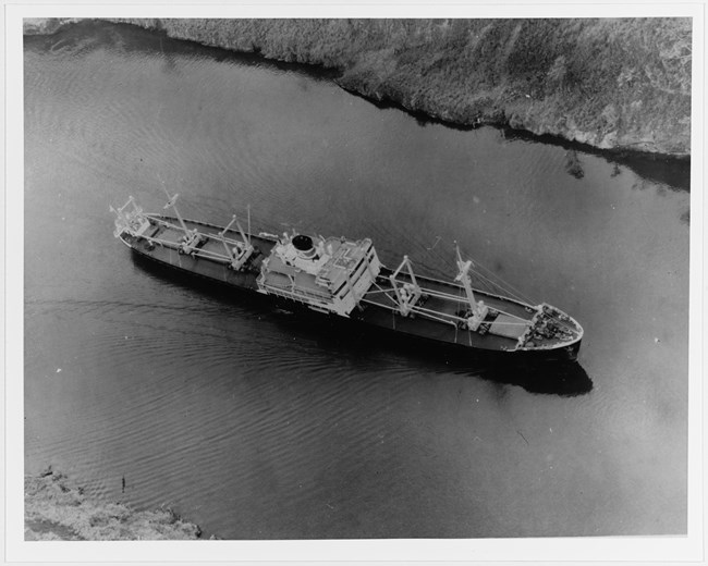 The Kano Maru in the Panama Canal, 1937 starboard bow aerial view of large transport ship in water.