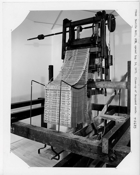 Jacquard Loom black and white historic photo of a machine with rows of material full of small holes