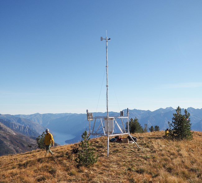 Person walking away from weather station.