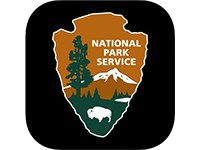 A National Park Service shield with tree, grass, and bison.