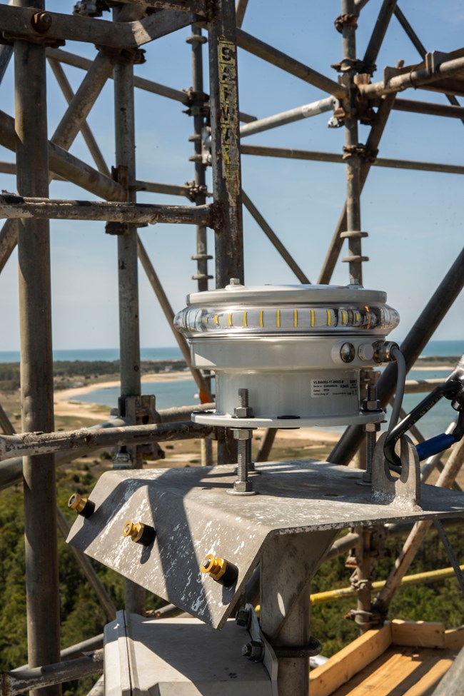 The exterior light installed on the scaffolding around the lighthouse. Image Credit: NPS Photo/S.Godin