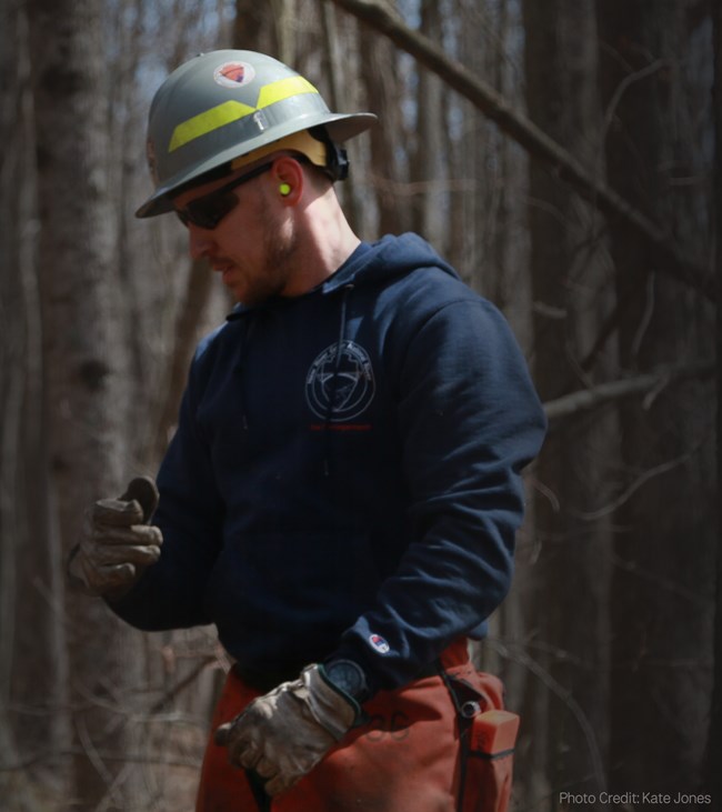 Closeup of a male wildland firefighter with forest in the background