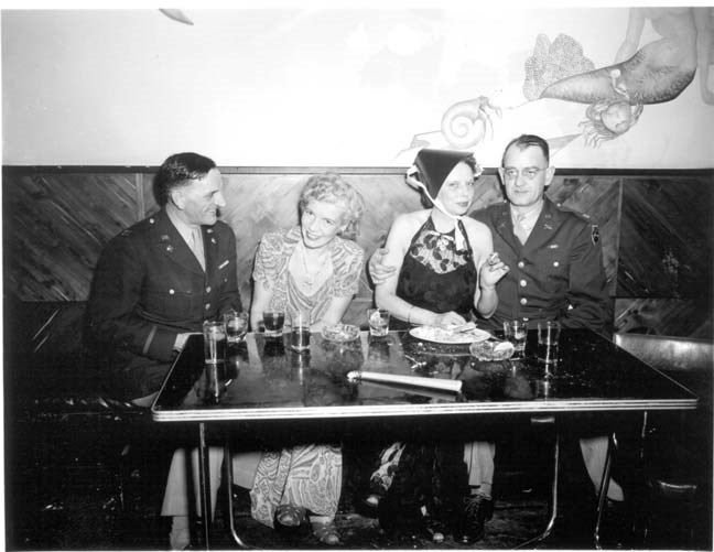 two couples sit at a table