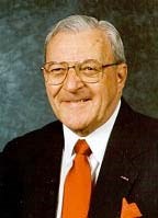 an older white man with grey hair in a suit