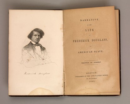 Photograph of the book Narrative of the Life of Frederick Douglass an American Slave, a young Frederick Douglass is pictured in the illustration.