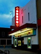 lt= Neon Sign on the side of a building.