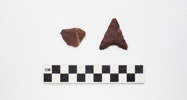A triangular shaped projectile point with concave shaped base.
