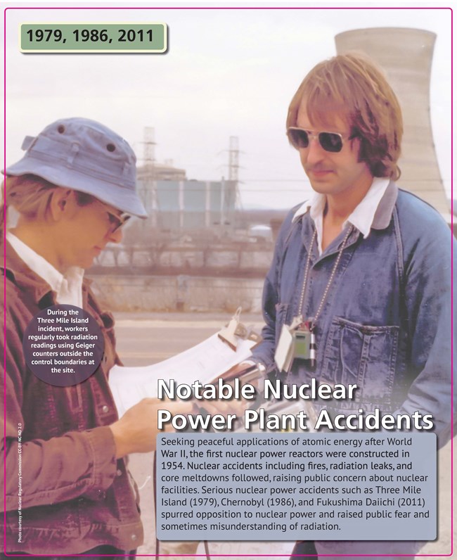 Nuclear Accidents A man and woman standing outside a nuclear power plant cooling tower, holding clipboards.
