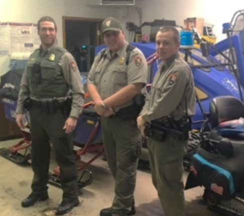 Park Ranger Kevin Grossheim and other NPS staff. Photograph of three people standing and smiling at camera.