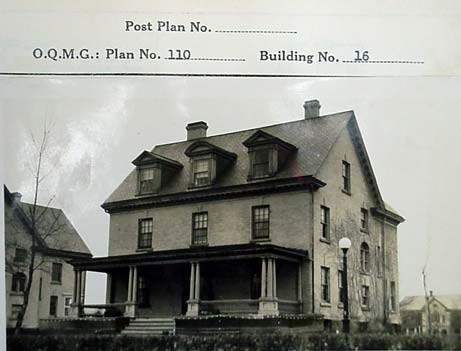 a three-story building with a simple facade and front porch