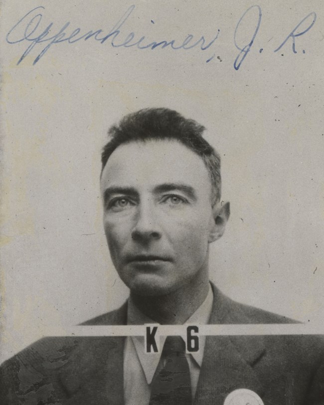 Oppenheimer poses for his Los Alamos ID photo. “K6” is in text in front of his necktie.