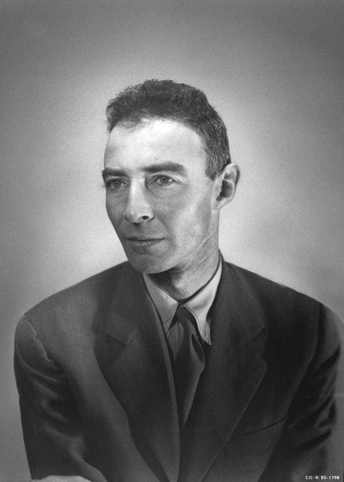 Black and white portrait photo of Oppenheimer in suit