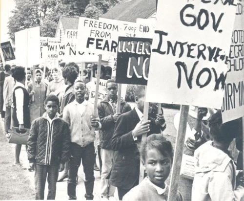 Protesters marching and holding signs Protesters marching and holding signs