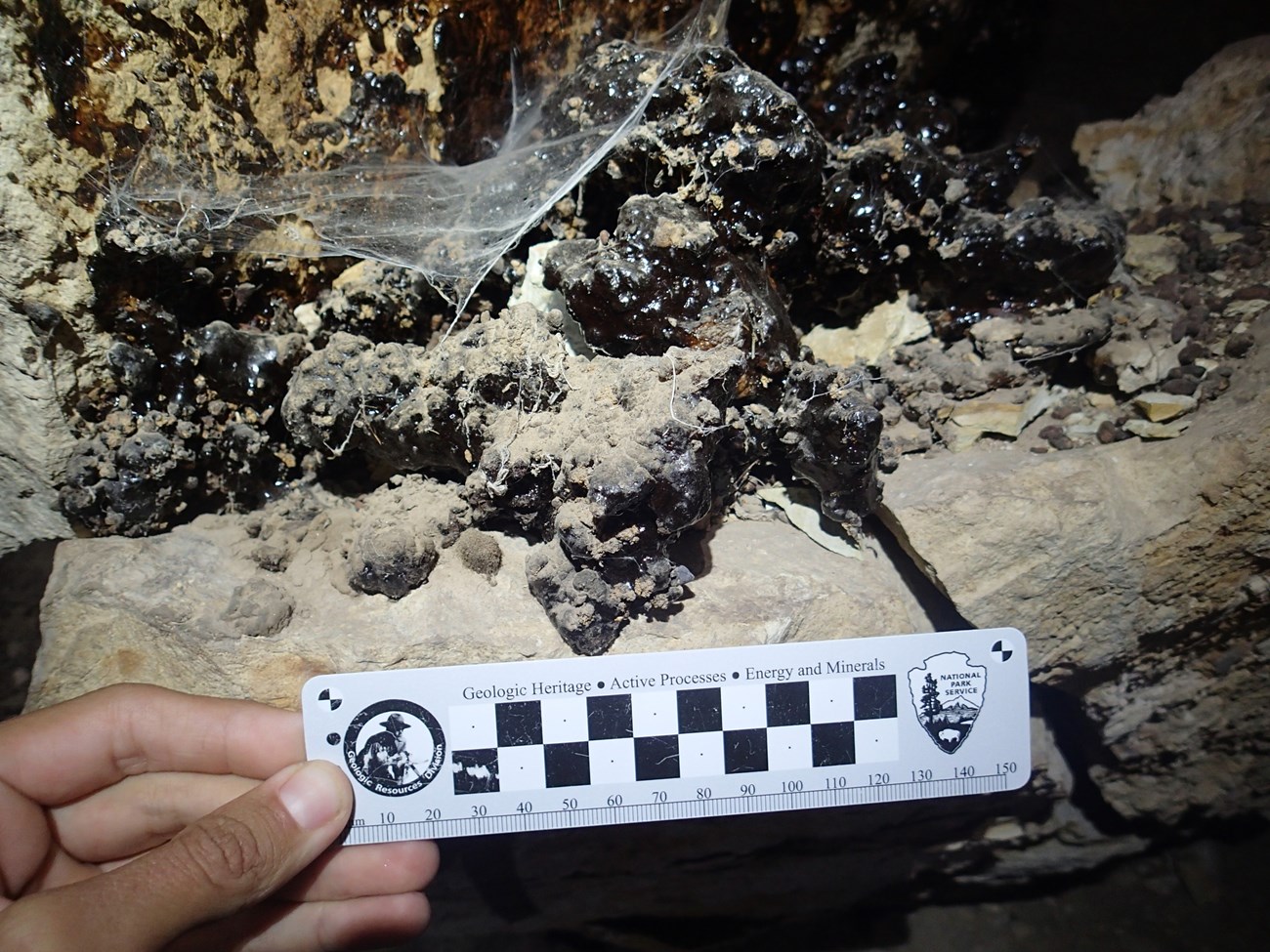 PB030595 blocky dark deposit with ruler for scale
