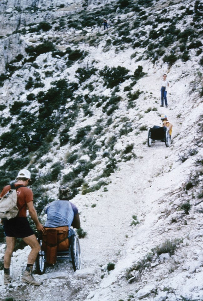 Men in wheelchairs ascend the Guadalupe peak trail