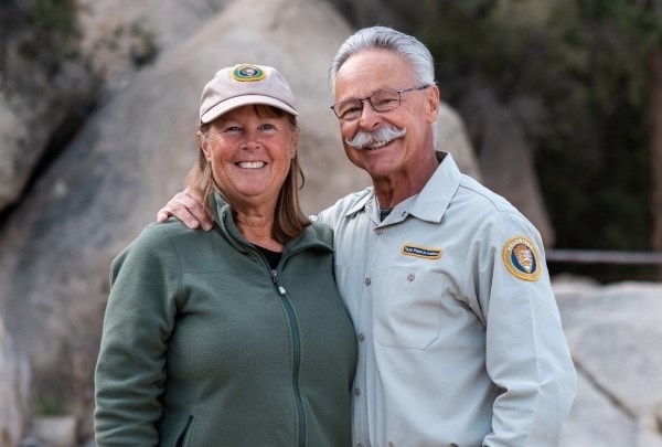 Heidi and Ron Jaramillo stand in front of boulders.