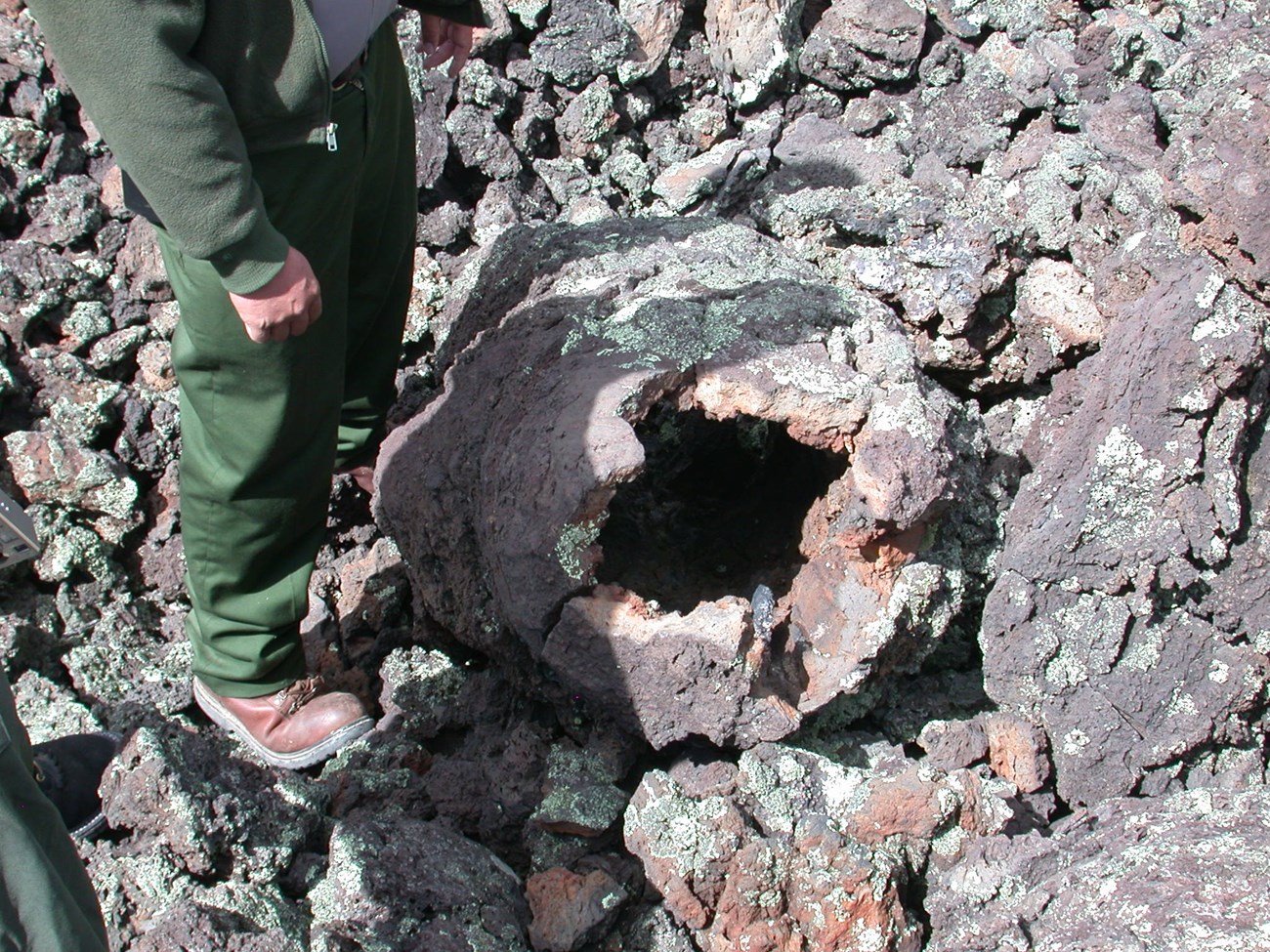 Pack Trail Tree Molds 004 photo of a ringer standing by a round hole in a rocky surface
