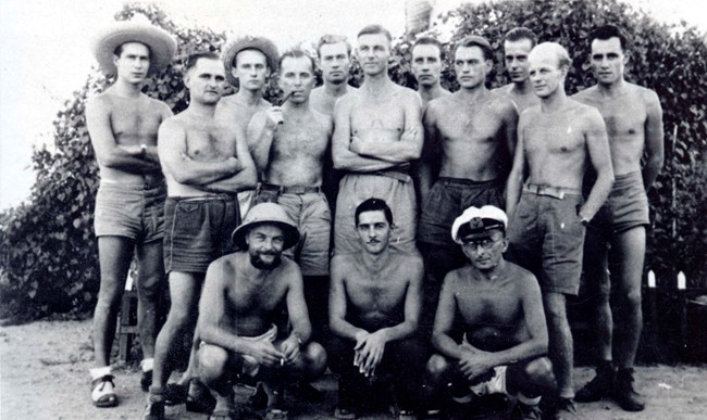 Papago Escapees, Group Photo Black and white photograph of escaped german prisoners of war from lake papago, Arizona. 11 of the 14 men are standing, 3 are sitting.