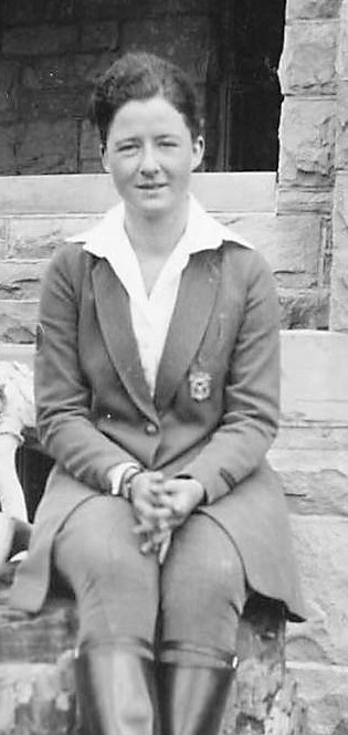 Margeurite Lindsley in uniform sitting on a petrified stump