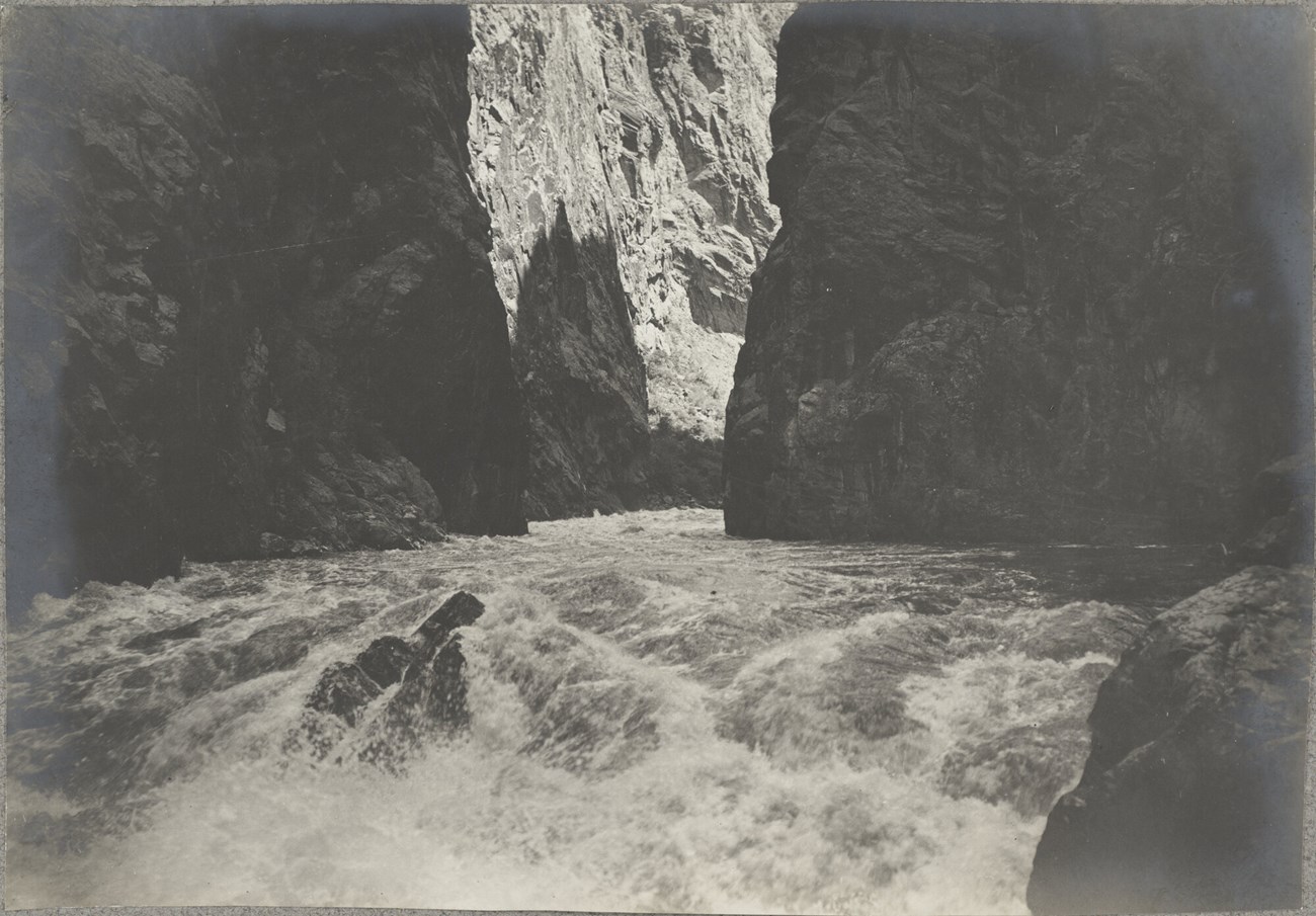 Pelton 1900 expedition Historic image of Gunnison River rapids rushing between cliffs in the Black Canyon of the Gunnison