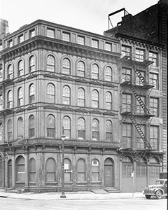 Penn Mutual Building Five story cast-iron building with arched window frames and a fire escape stairs on the side