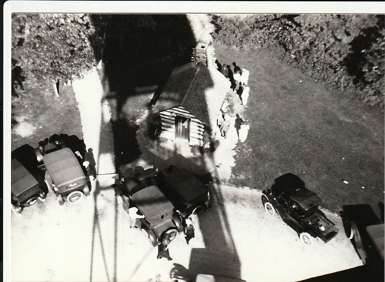 A birds eye view of a parking area with old cars.