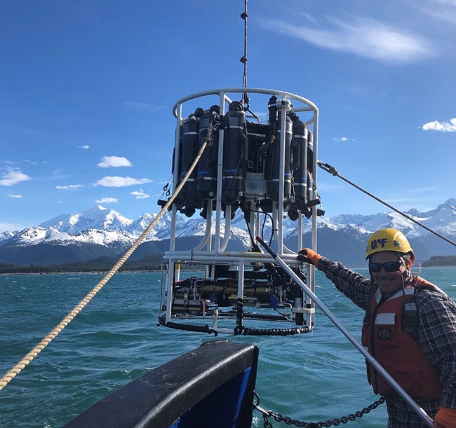 Peter_CTD_Fairweather_web A man deploys scientific instrument from a boat to the ocean.