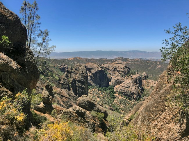 Pinnacles rock formations Rocks of various sizes and textures emerge from dry chamise and gray pine woodlands.