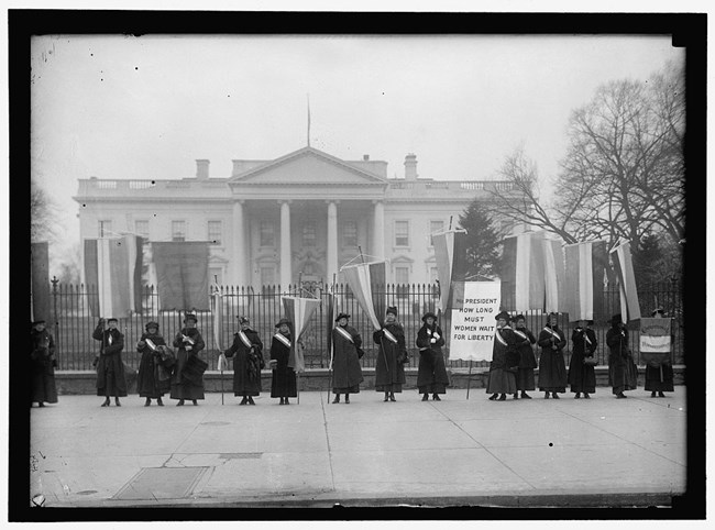 Women suffragists picket in front of the White House circa 1917.