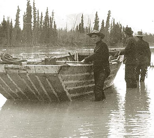 A heavy wooden boat in a historical photo.